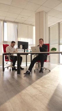 Bir ofiste çalışan iki beyaz adam.