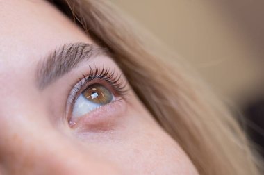 Kirpik kaplama prosedüründen sonra bir kadının gözlerine yakın çekim
