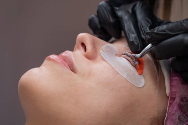 Beyaz kadın kirpik temizleme prosedüründen geçiyor.