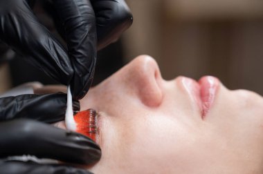 Beyaz kadın kirpik temizleme prosedüründen geçiyor.