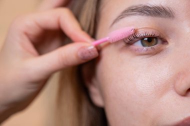 Beyaz kadın kirpiklerini fırçalıyordu.