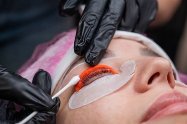 Beyaz kadın kirpik temizleme prosedüründen geçiyor.