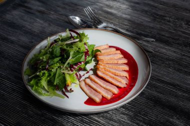 Kızarmış ördek bir tabakta parçalara ayrılmış.