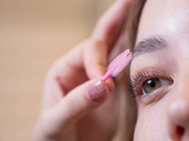 Beyaz kadın kirpiklerini fırçalıyordu.