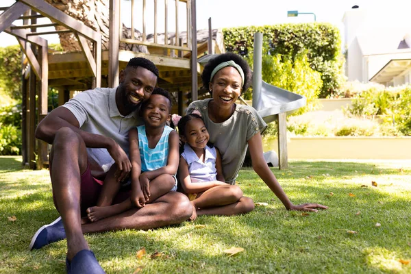 Volledige Lengte Van Vrolijke Afrikaanse Amerikaanse Ouders Kinderen Zittend Grasveld — Stockfoto
