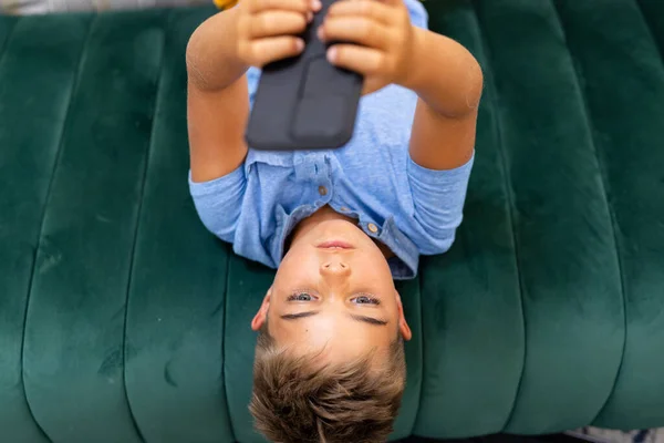 高角镜下的高加索男孩躺在客厅沙发上使用手机 复制空间 不变的生活方式 技术和家庭观念 — 图库照片
