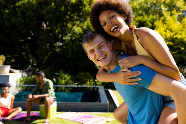 一对快乐的 多样化的夫妇在花园里互相搭便车和微笑的画像 生活方式 聚会时间 假期和夏天 — 图库照片