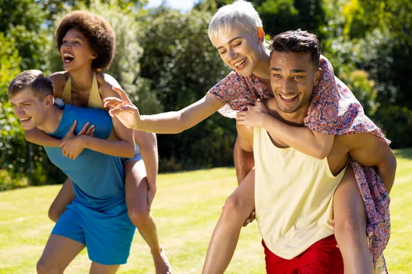 Happy Diverse Group Friends Giving Each Other Piggyback Rides Garden — Stock Photo, Image