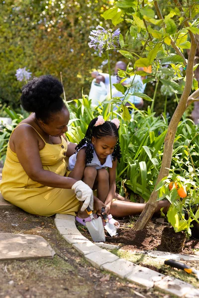African American Grandmother Granddaughter Digging Soil Tools While Gardening Yard — Stock Photo, Image
