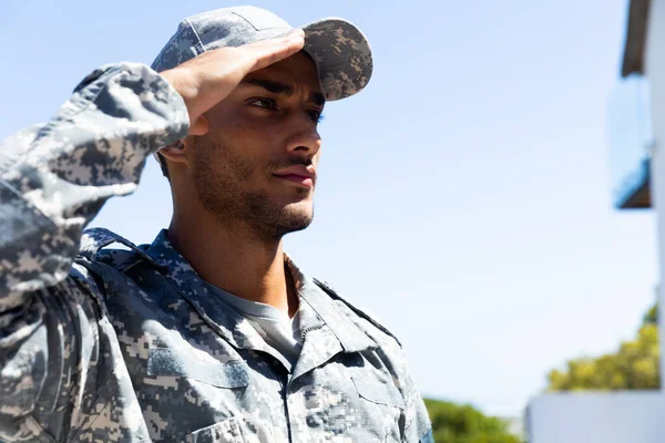 Biracial Mannlig Soldat Iført Militær Uniform Hilser Utendørs Med Kopiplass – stockfoto