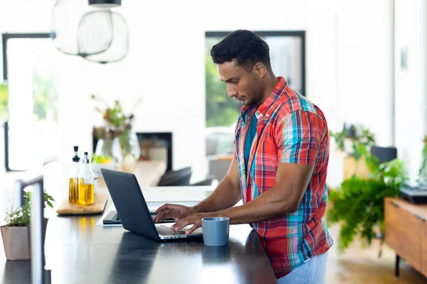 Happy Biracial Man Leaning Standing Countertop Using Laptop Kitchen Lifestyle — Stock Photo, Image