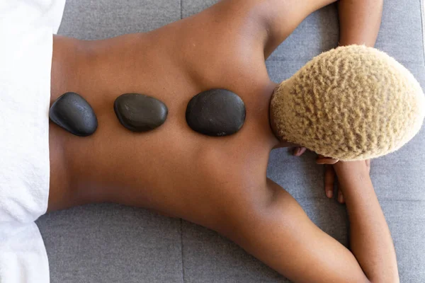 Happy African American Woman Lying Hot Stones Her Back Spa — Stock Photo, Image