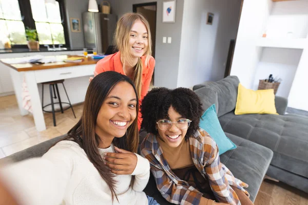 Portrait Happy Diverse Teenage Female Friends Sitting Couch Taking Selfie — Stock Photo, Image