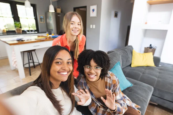 Portrait Happy Diverse Teenage Female Friends Sitting Couch Taking Selfie — Stock Photo, Image