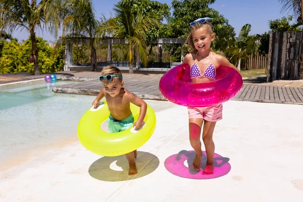 Happy Biracial Brother Sister Holding Swim Rings Swimming Pool Spending — Stock Photo, Image