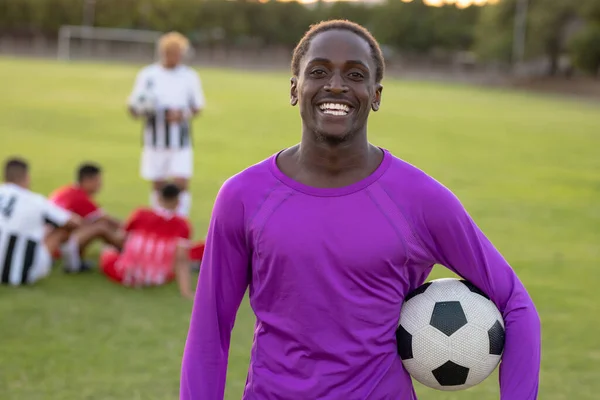 Portret Szczęśliwego Afrykańskiego Bramkarza Piłką Nożną Stojącego Placu Zabaw Zachodzie — Zdjęcie stockowe
