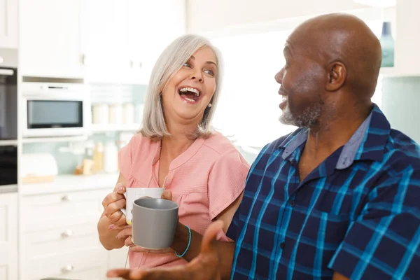 Happy Senior Diverse Couple Drinking Coffee Kitchen Spending Quality Time — Stock Photo, Image