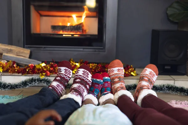 アフリカ系アメリカ人の家族の靴下を着てリビングルームに座っているの低セクション クリスマスに家で家族の時間を過ごす — ストック写真