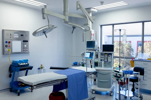 Medical equipment, technology and lighting over operating table in empty hospital operating theatre. Hospital, medical and healthcare services.