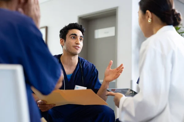 Biracial Male Doctor Holding File Sitting Discussion Diverse Female Colleagues — Stock Photo, Image