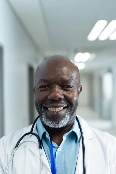 病院の廊下 コピースペースで笑顔シニアアフリカ系アメリカ人男性医師の垂直肖像画 医療サービス — ストック写真