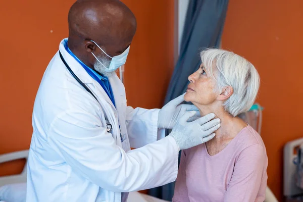 Diverse Senior Male Doctor Face Mask Examining Throat Senior Female — Stock Photo, Image