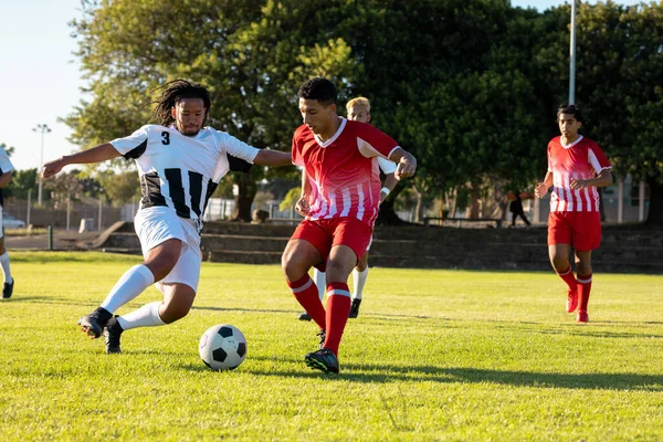 Multiraciale Mannelijke Spelers Lopen Jagen Bal Tijdens Voetbalwedstrijd Speelplaats Rivaliteit — Stockfoto