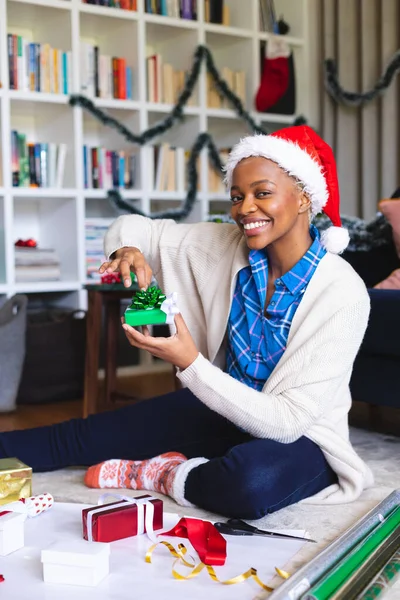 Happy African American Woman Wearing Santa Claus Hat Packing Presents — Stock Photo, Image