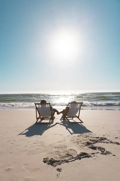 African American Senior Couple Holding Hands Relaxing Deckchairs Front Seascape — Stock Photo, Image
