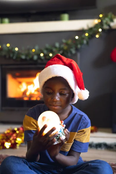 Vertical Picture African American Boy Holding Christmas Snowing Ball Siting — Stock Photo, Image