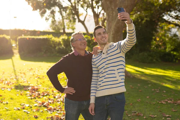 幸せな白人の父親と大人の息子のイメージが庭で自撮り 家族と一緒に質の高い時間を過ごすコンセプト — ストック写真