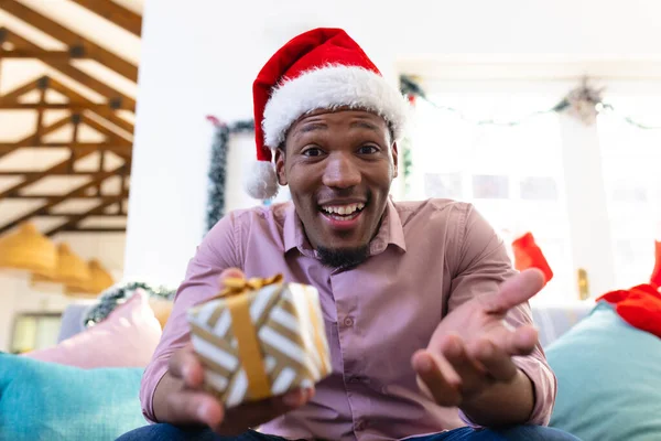 快乐的非洲裔美国人戴着圣塔克洛斯帽 有视频通话 一个人在圣诞节消磨时光 — 图库照片