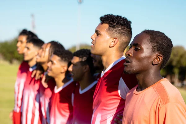 Multiracial Male Players Red Uniforms Looking Away Standing Side Side — Stock Photo, Image