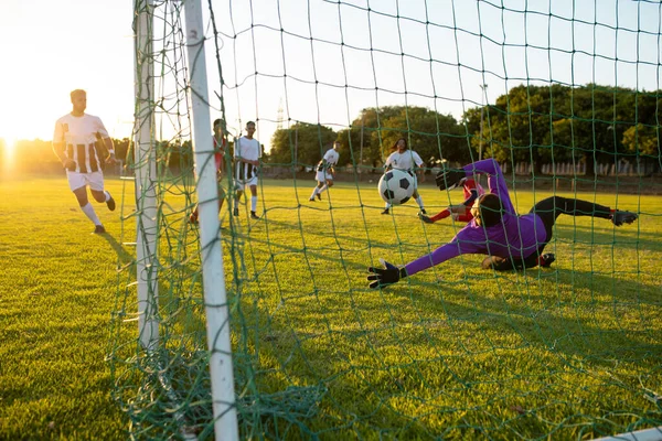 Multiracial Goalkeeper Defending Ball Opponent Goal Match Clear Sky Sunset — Stock Photo, Image