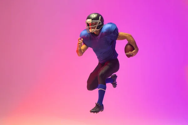Caucasian Male American Football Player Holding Ball Neon Pink Lighting — Stock Photo, Image
