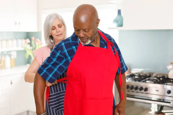 Happy Senior Diverse Couple Wearing Aprons Kitchen Spending Quality Time — Stock Photo, Image