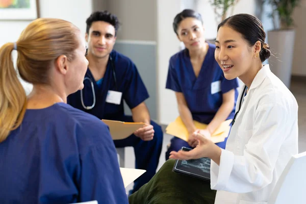 Smiling Asian Female Doctor Tablet Sitting Discussion Diverse Colleagues Hospital — Stock Photo, Image
