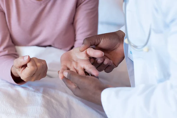 Midsection Diverse Senior Male Doctor Examining Hand Senior Female Patient — Stock Photo, Image