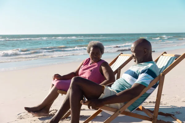 African American Senior Couple Talking While Relaxing Deckchairs Seascape Clear — Stock Photo, Image