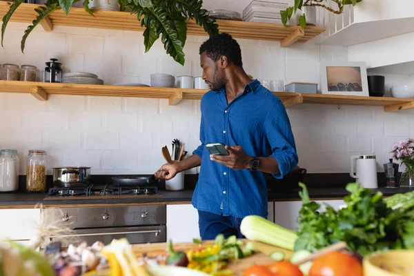 Happy African American Man Cooking Dinner Kitchen Using Smartphone Spending — Stock Photo, Image