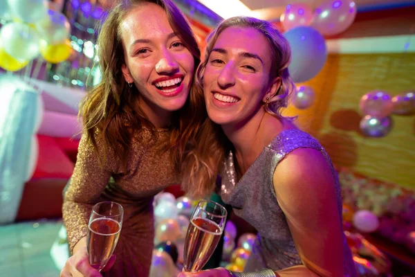 Portrait Two Happy Caucasian Female Friends Laughing Drinking Champagne Nightclub — Stock Photo, Image
