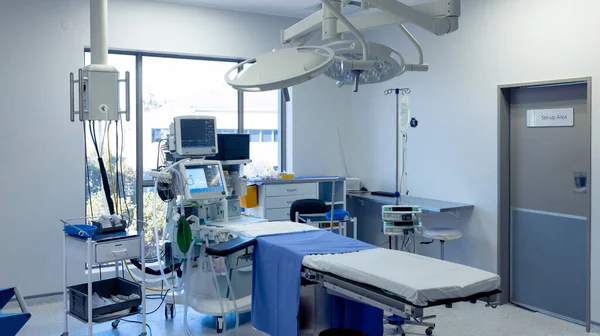 Medical equipment, technology and lighting over operating table in empty hospital operating theatre. Hospital, medical and healthcare services.
