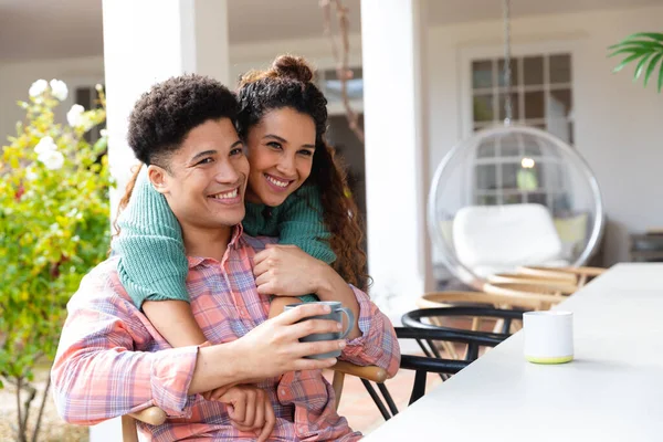 Happy Biracial Couple Garden Terrace Embracing Drinking Coffee House Smiling — Stock Photo, Image