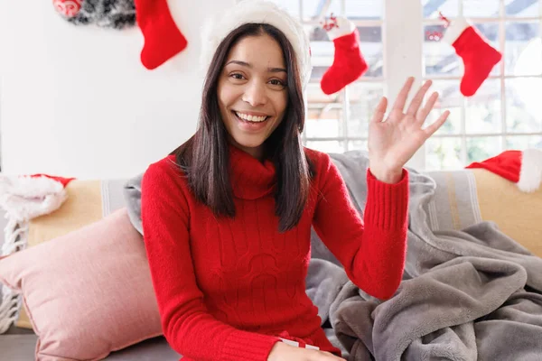 Happy Biracial Woman Wearing Santa Hat Sitting Sofa Living Room — Stock Photo, Image