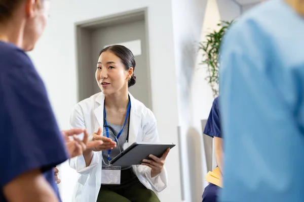 Smiling Asian Female Doctor Tablet Sitting Discussion Diverse Colleagues Hospital — Stock Photo, Image
