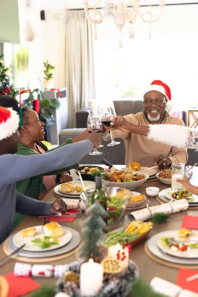 Pionowy Obraz Afrykańskiej Rodziny Jedzącej Świąteczny Posiłek Pijącej Wino Boże — Zdjęcie stockowe