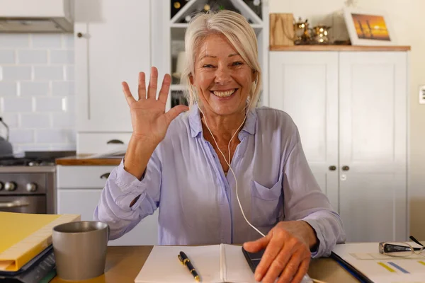 Happy Senior Caucasian Woman Wearing Earphones Sitting Table Kitchen Having — Stock Photo, Image