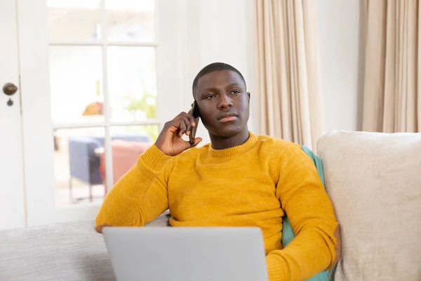Sérieux Homme Afro Américain Utilisant Ordinateur Portable Parlant Sur Smartphone — Photo