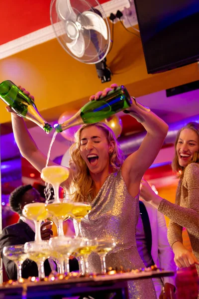 Šťastná Běloška Nalévá Fontánu Šampaňského Sklenic Různými Přáteli Nočním Klubu — Stock fotografie
