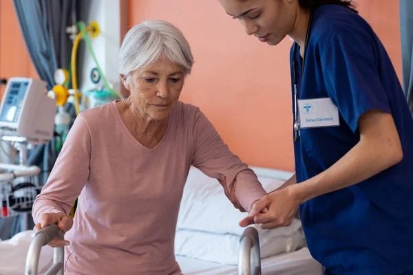 Diverse Female Doctor Helping Senior Female Patient Use Walking Frame — Stock Photo, Image